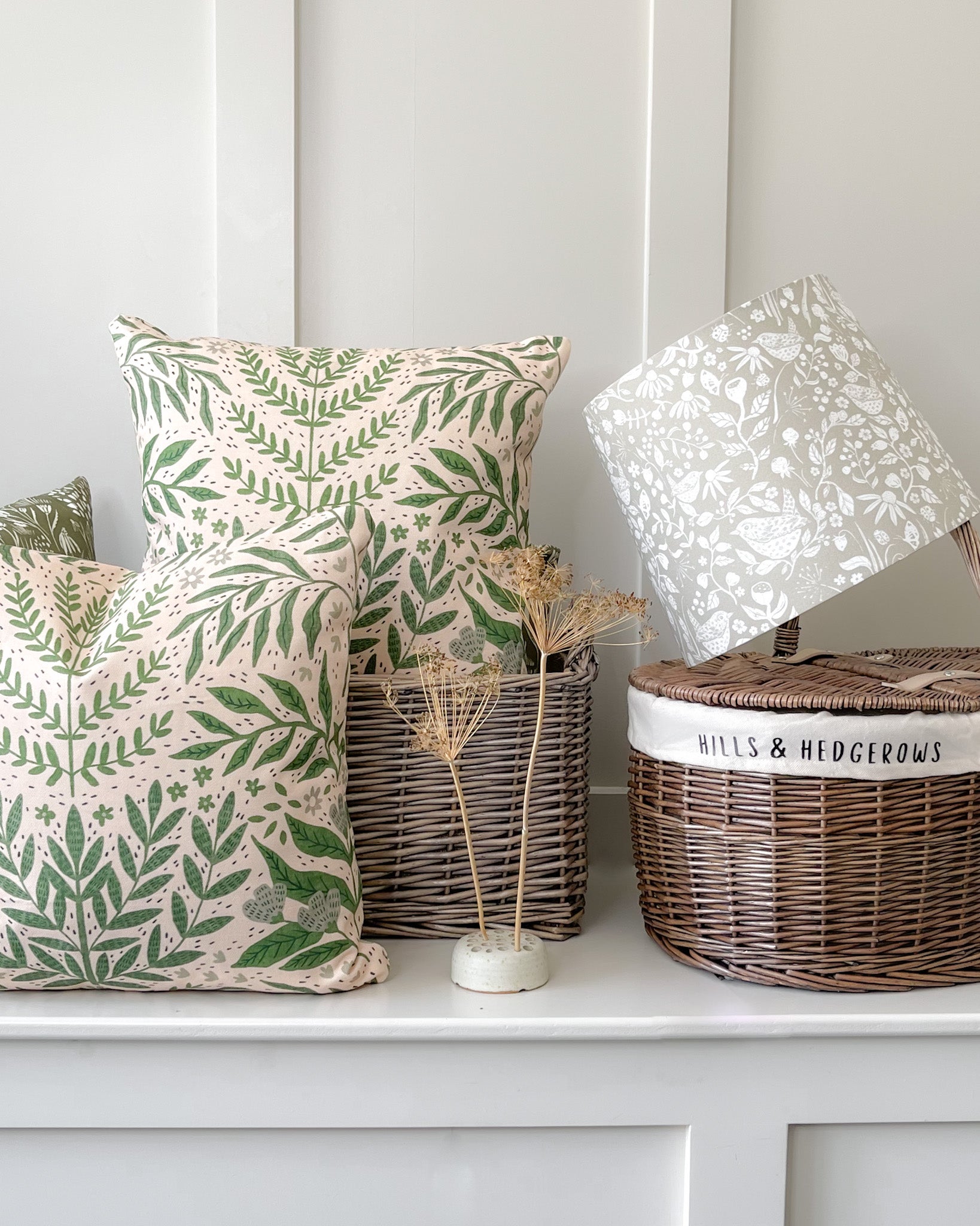 Handcrafted botanical-themed scatter cushions and lampshades from Hills & Hedgerows, adding natural charm to home decor.