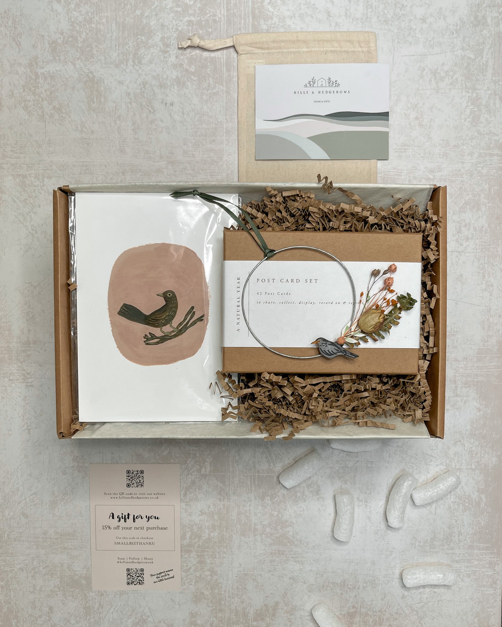 Gift set featuring a natural year postcard set, lady blackbird Gemma Koomen print, and dried foraged wreath with a little blackbird.