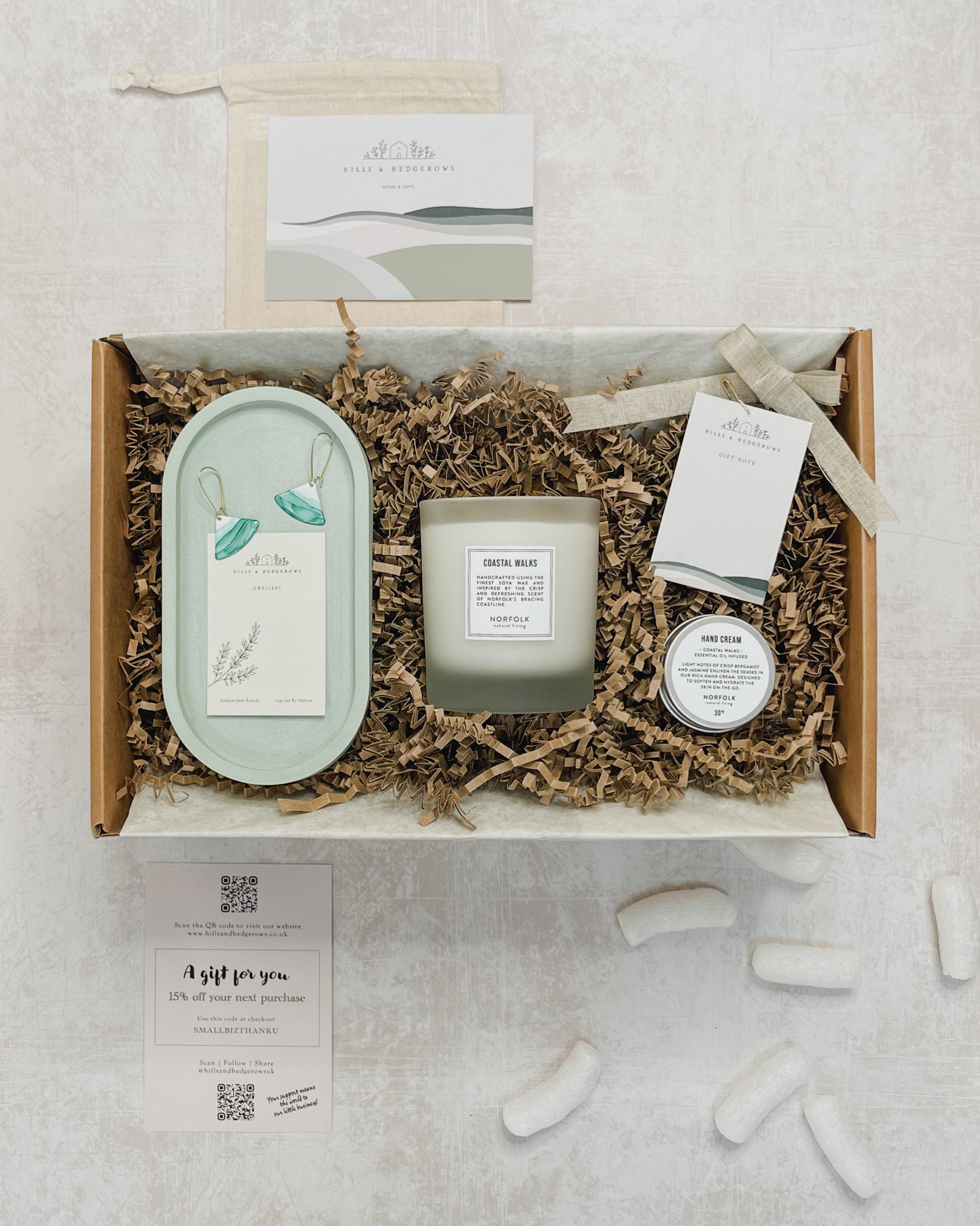 Beautifully curated Sea Greens Gift Set featuring a green concrete oval tray, sea green waves earrings, Norfolk Natural Living coastal candle, and hand cream, perfect for serene and elegant evenings.