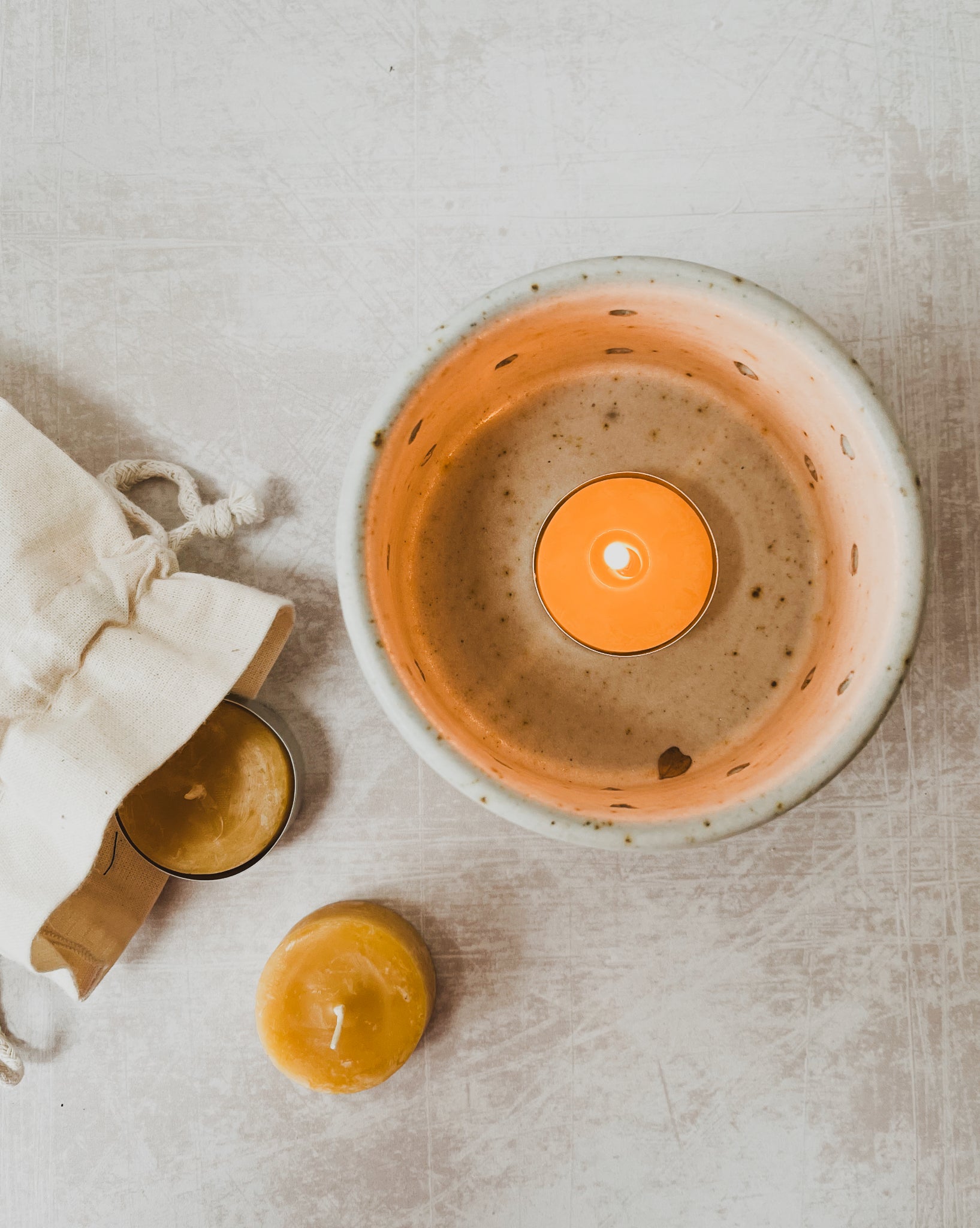 Handthrown Ceramic Candle Holder with Beeswax Tealight Gift Set from the Derbyshire Peak District, featuring a speckled clay design with polkadot punctures and raw off-white matte glaze.