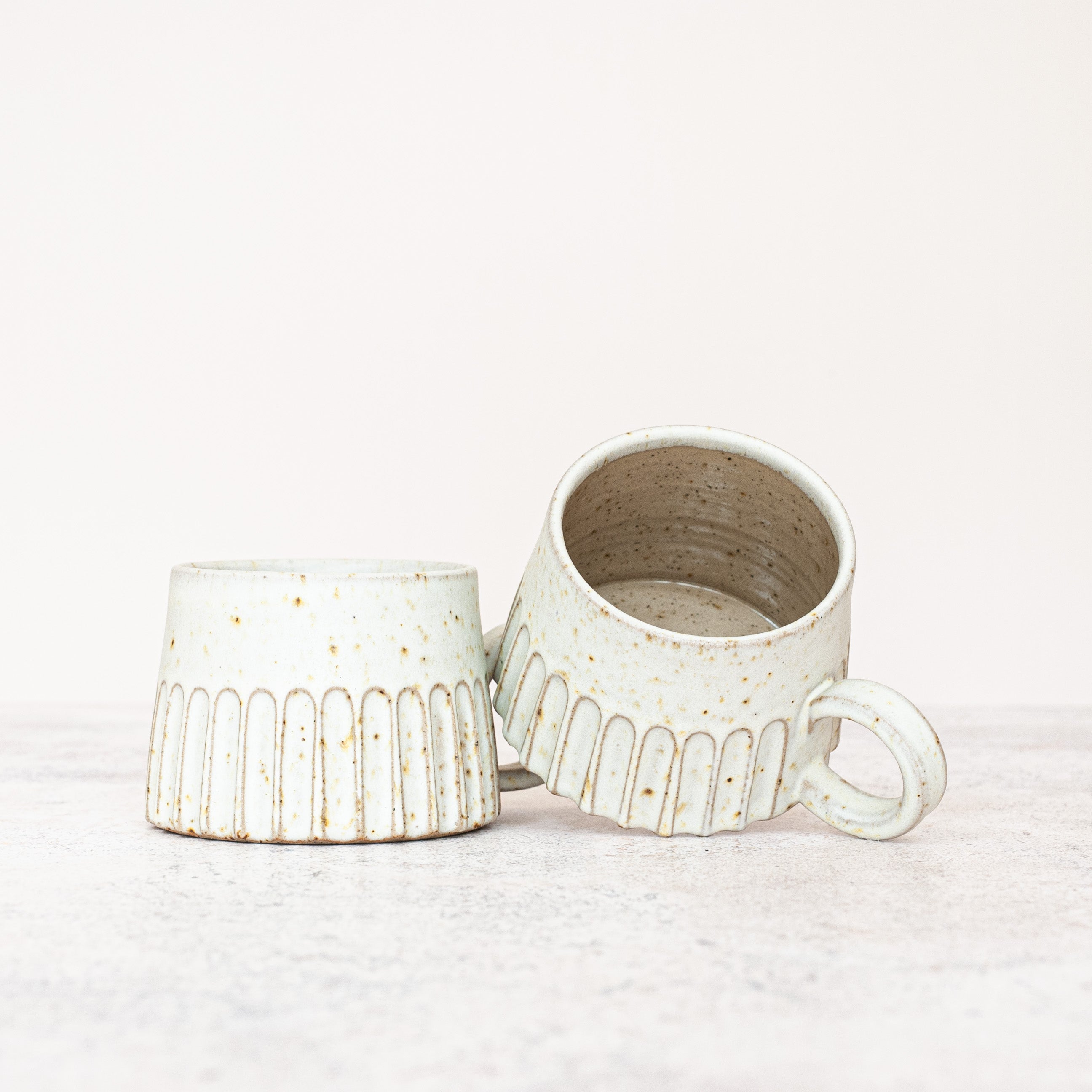 Hand-thrown carved and speckled large stoneware mug with a rustic finish and speckle glaze.