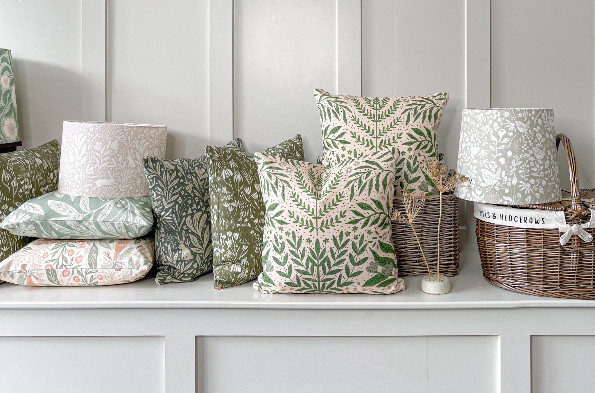 Handmade Nature-inspired decorative scatter cushions and handcrafted botanical lampshades on a bench