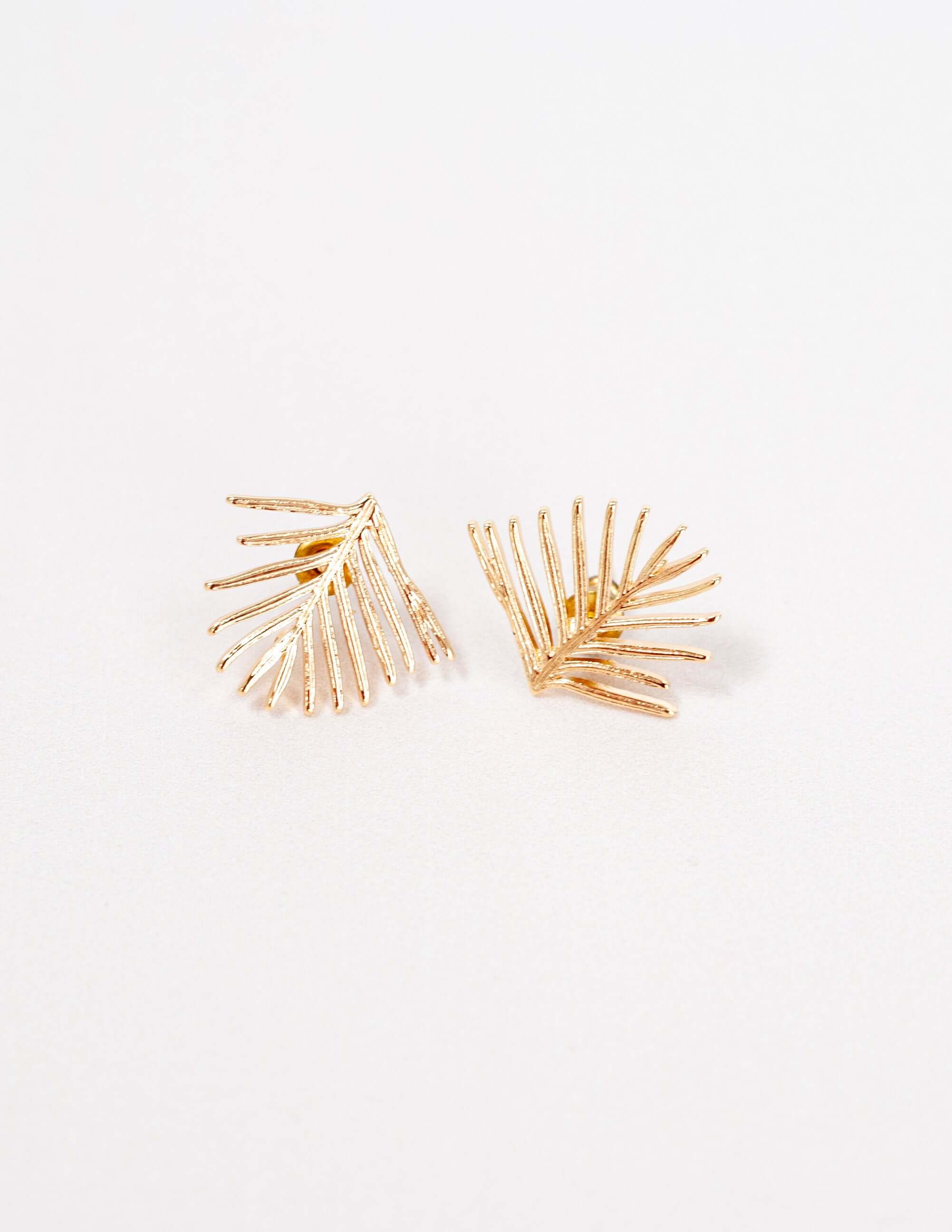 Handmade Evergreen Leaf Stud Earrings, gold-plated brass with a textured finish. Pine needle-inspired design, perfect for winter, gift-ready in a cotton pouch.