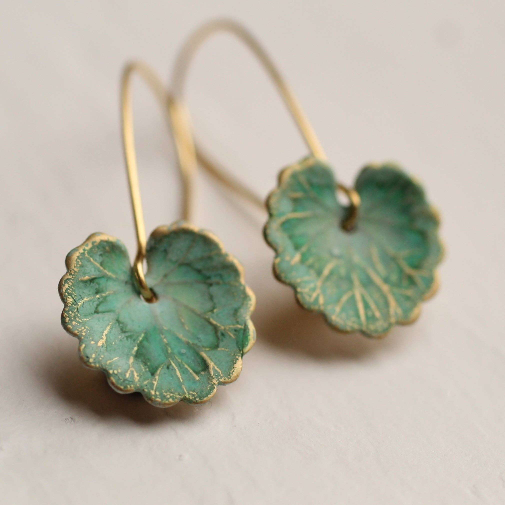 Handcrafted Lily Pad Leaf Earrings, Art Nouveau-inspired. Brass charms with intricate veining, made in Edinburgh. Perfect for autumn and winter, gift-ready in a cotton pouch.