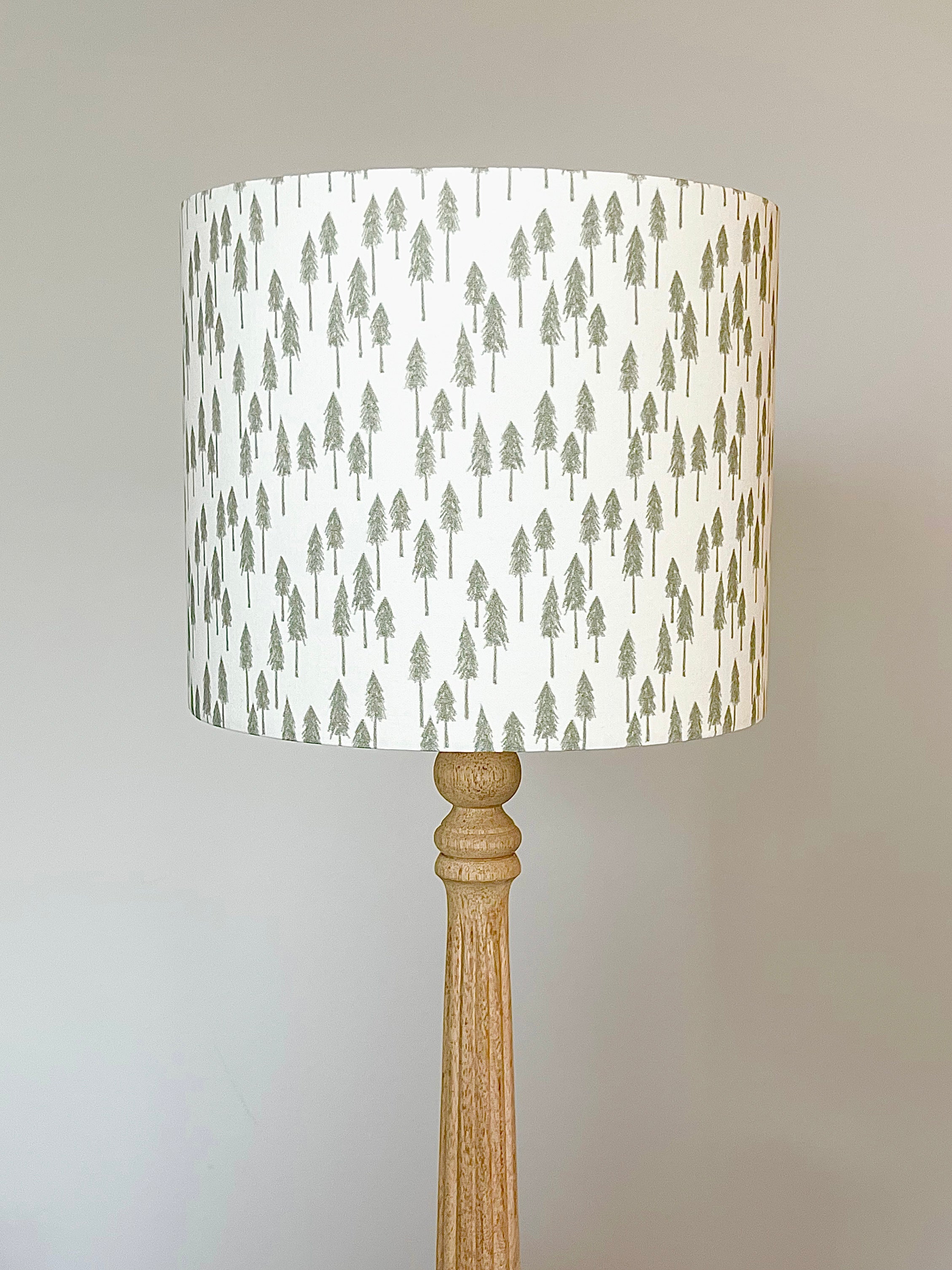 Evergreen Forest Pattern Lampshade by Hufton Studio, featuring minimalist evergreen trees in olive green on a warm cream background, handmade with cotton poplin fabric.