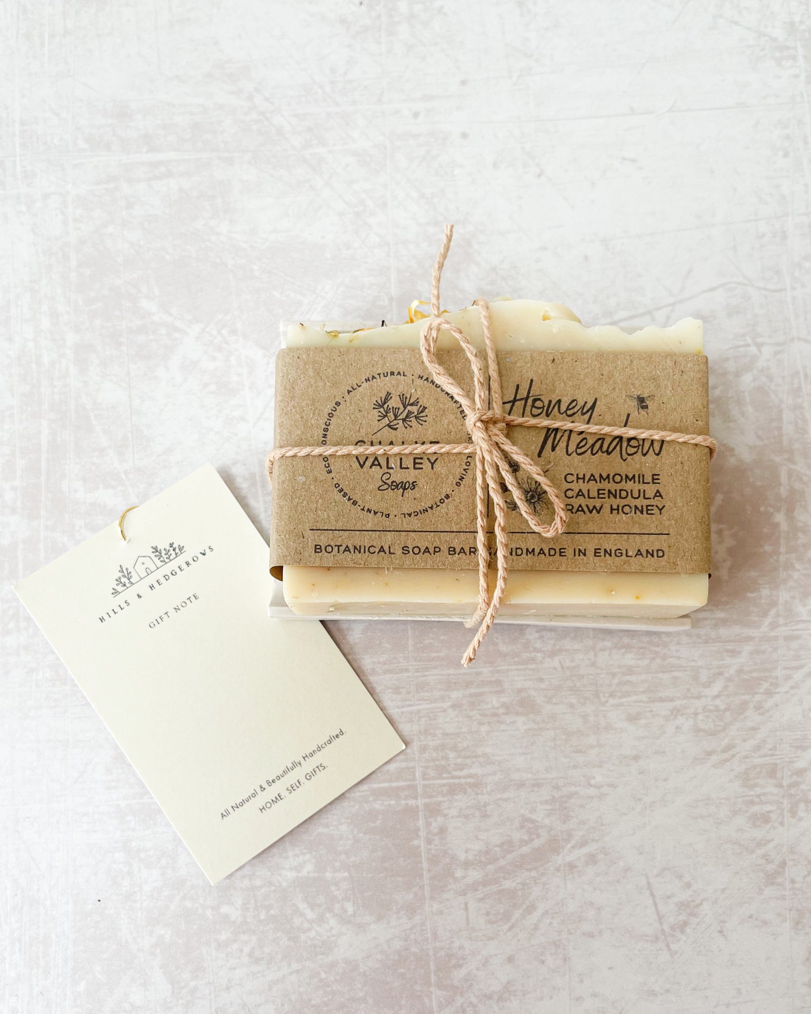 Natural essential oil botanical honey soap bar on neutral soap dish made in the UK With gift tag