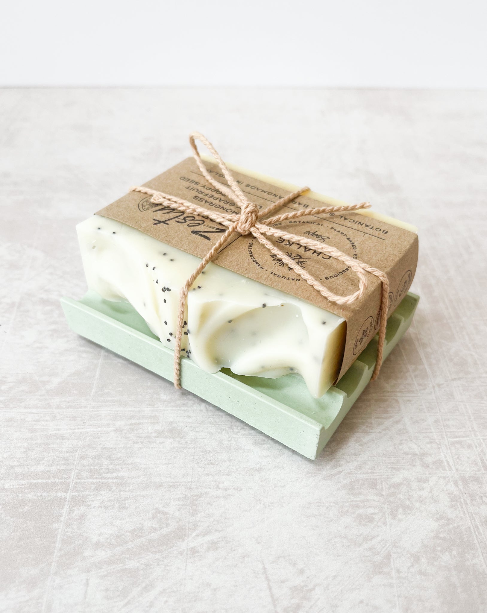 Natural essential oil botanical zesty soap bar on green soap dish made in the UK