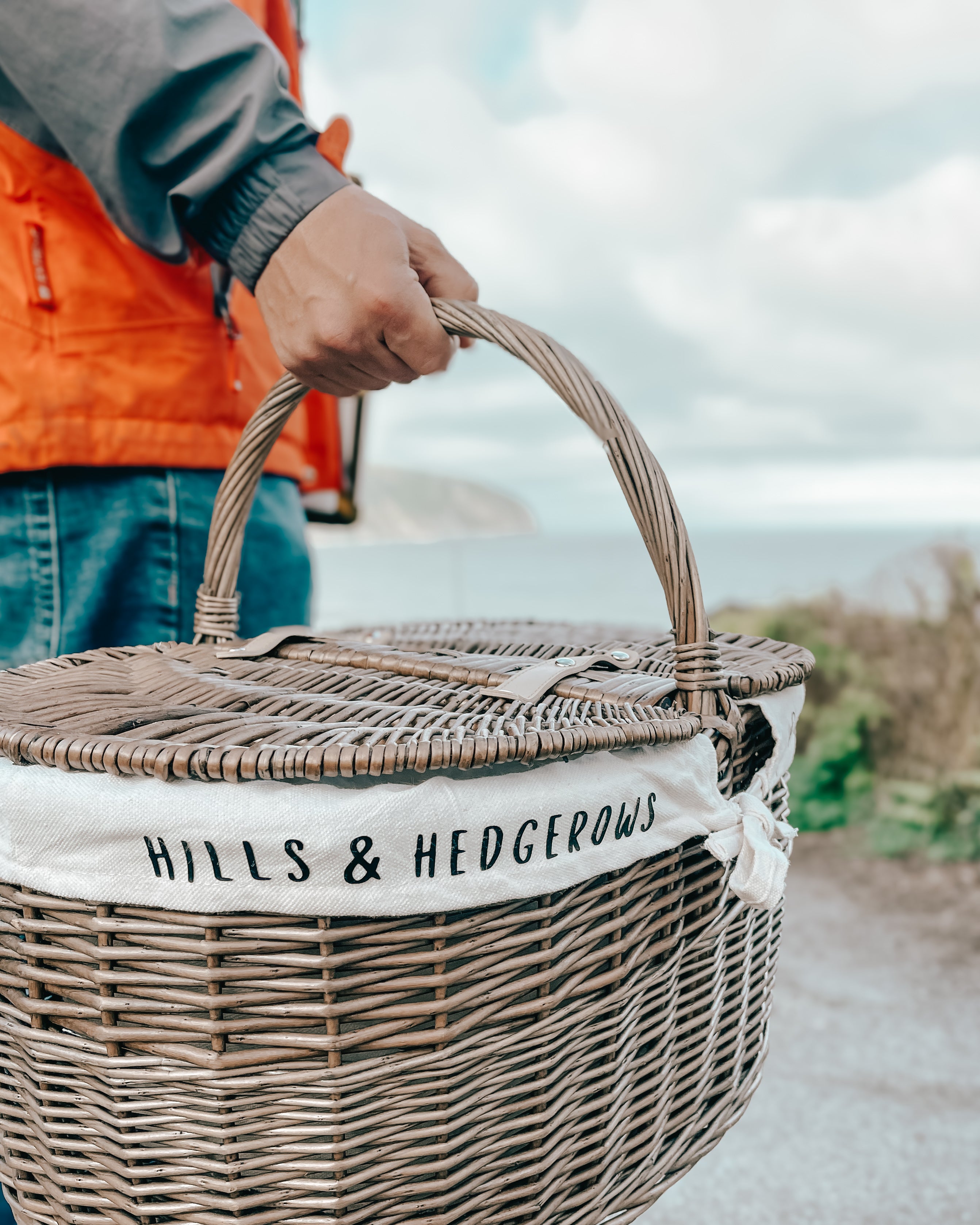 Hills & Hedgerows personalised picnic basket on a walk along the british coastline