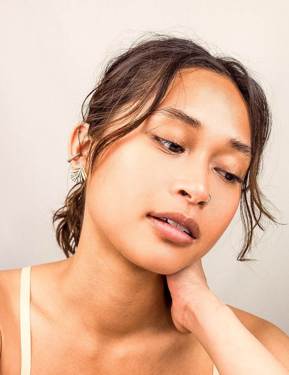 Handmade Evergreen Leaf Stud Earrings, gold-plated brass with a textured finish. Pine needle-inspired design, perfect for winter, gift-ready in a cotton pouch.