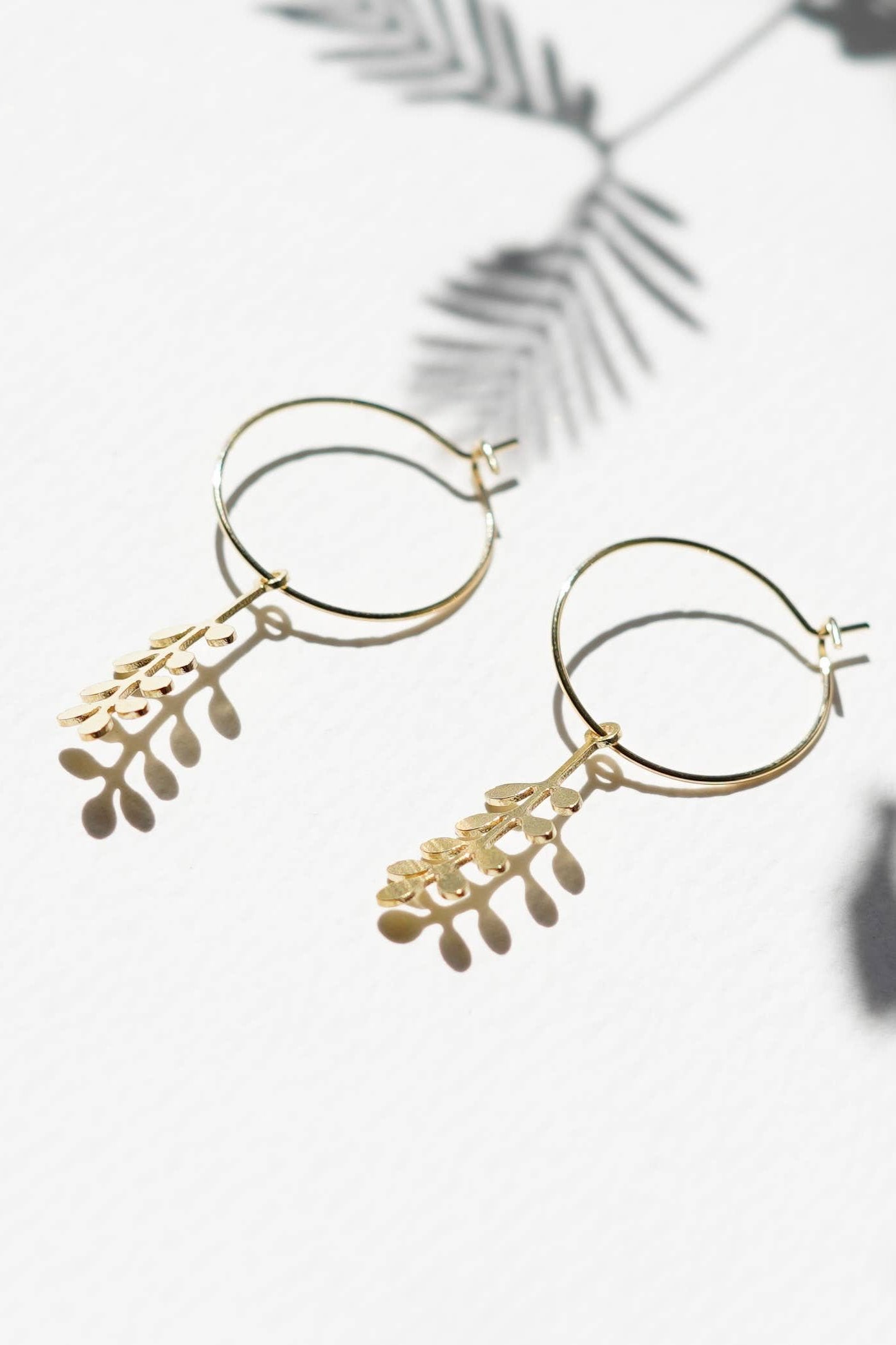 Handcrafted Sprig Hoop Earrings for autumn and winter, made in the UK. Delicate brass sprigs on 20mm gold-plated hoops. Lightweight and gift-ready in a cotton pouch.